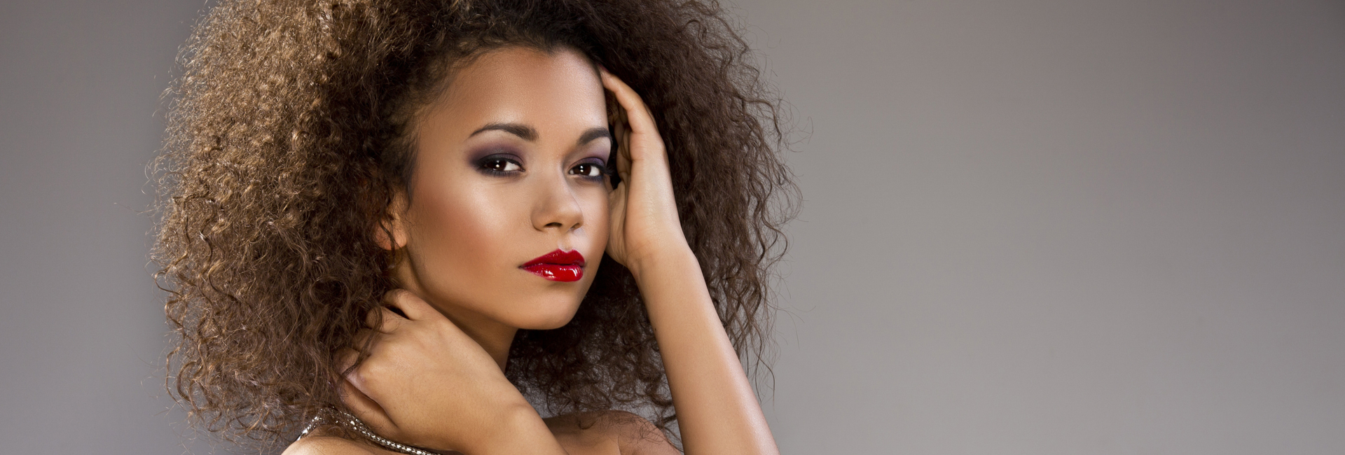 Beautiful woman with curly hair and red lipstick