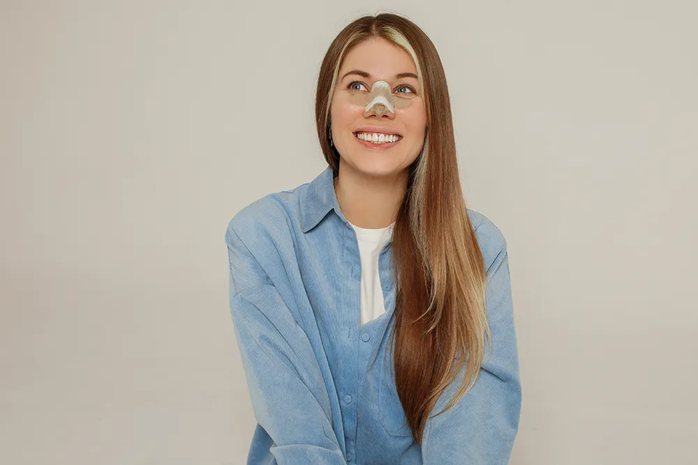 woman smiling after rhinoplasty procedure