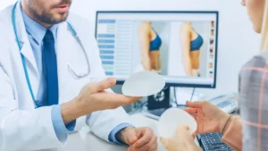 doctor showing a patient a breast implant