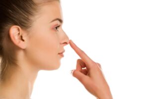 Woman touching nose